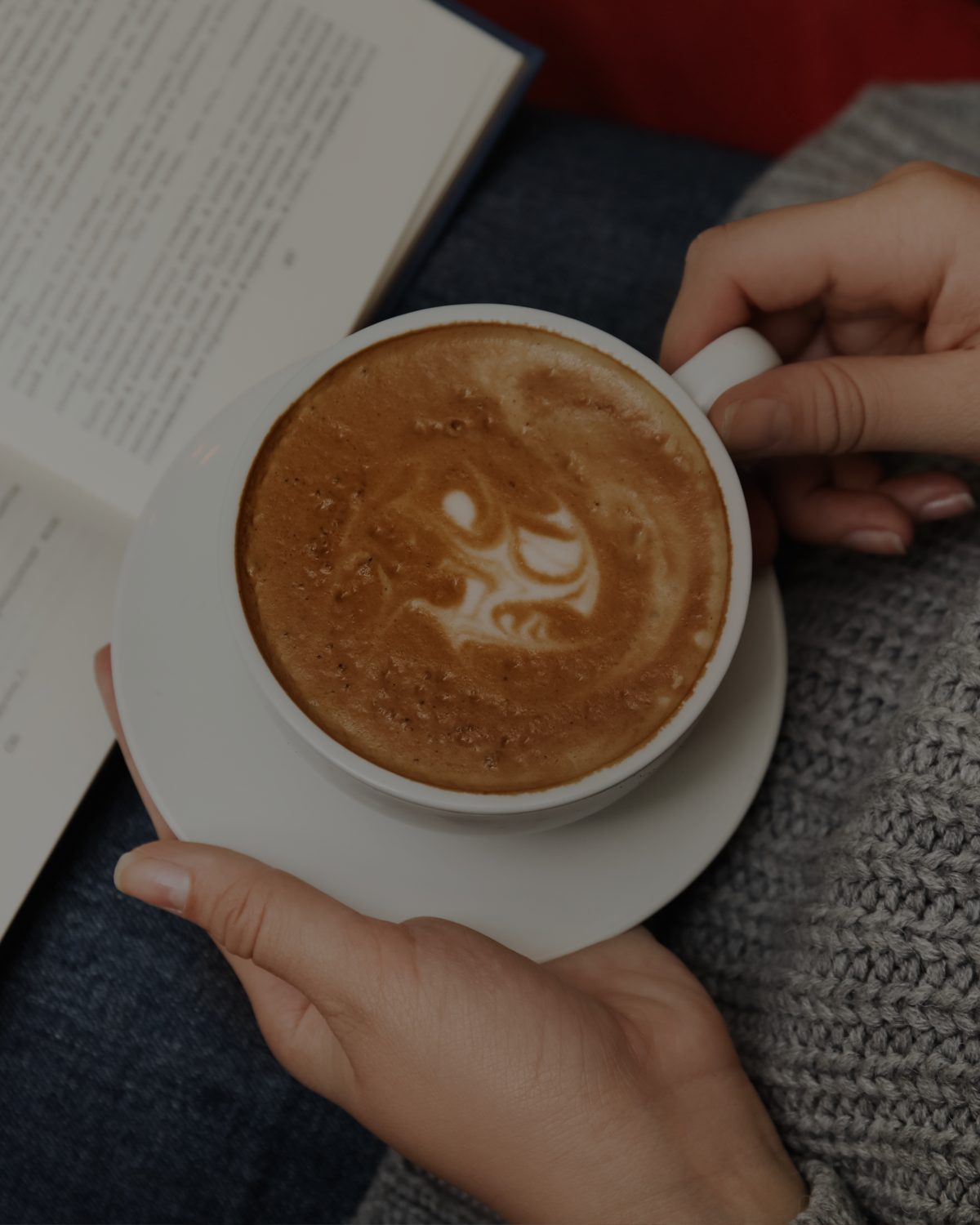 A latte next to an open book