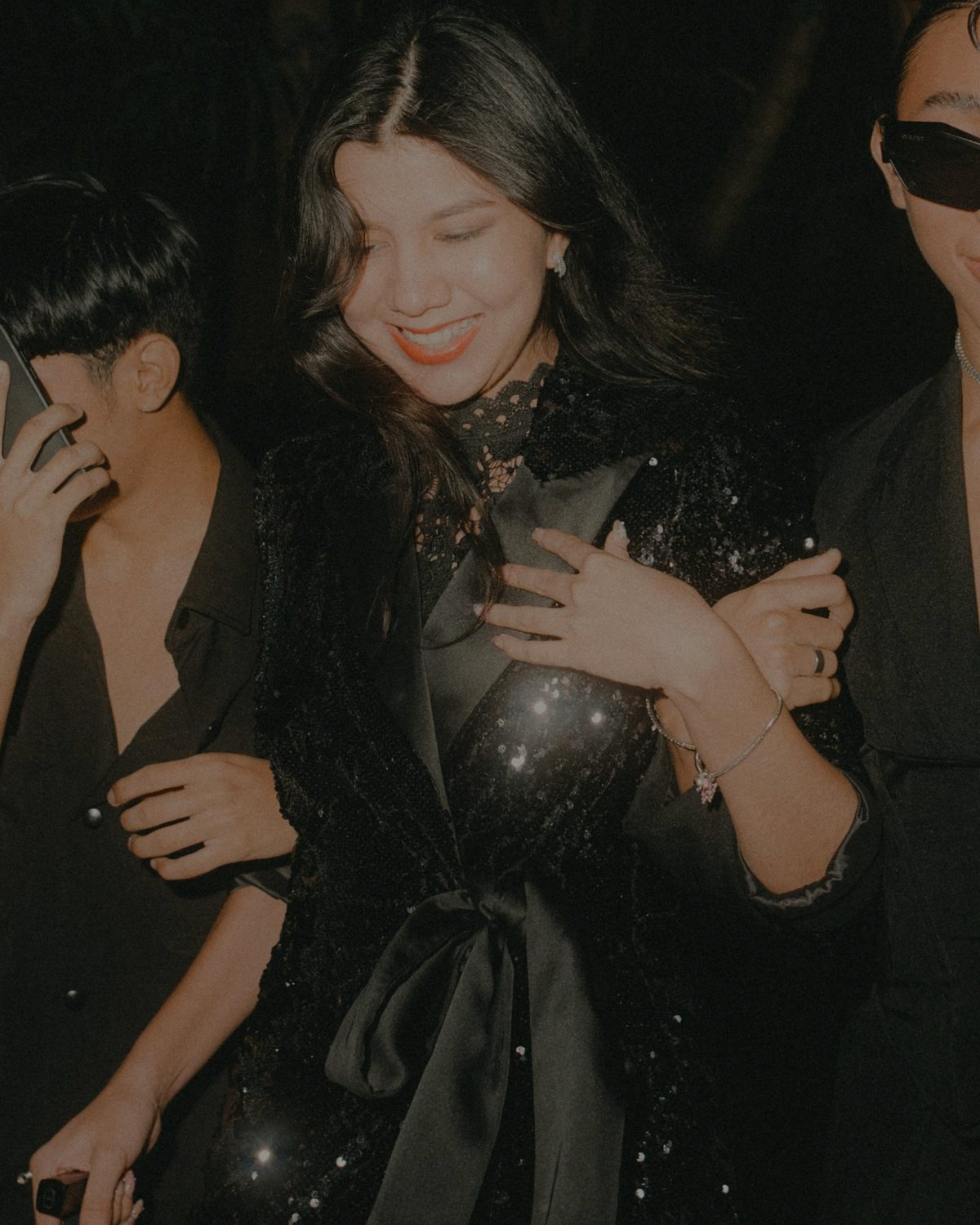 Friends arm in arm on a night out