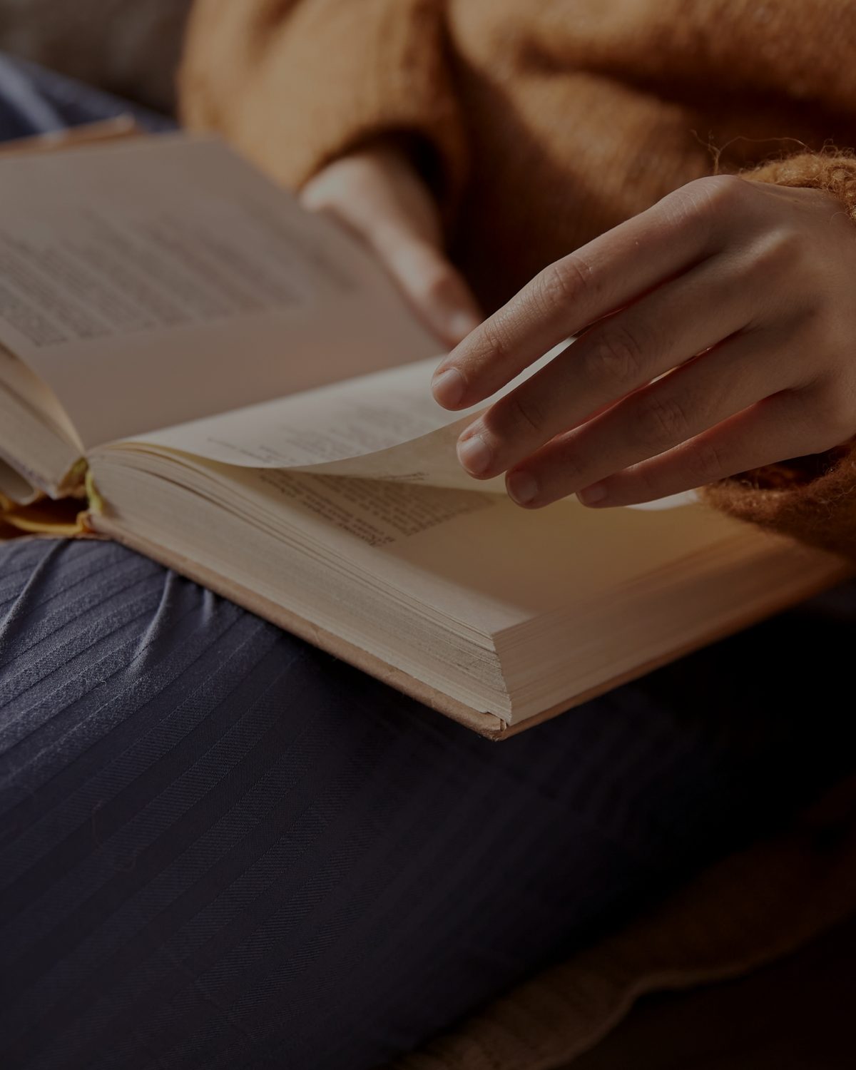 A hand turning the page of a book